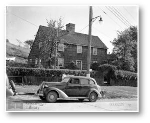 Historic image of a house in Greenwich with a car in front
