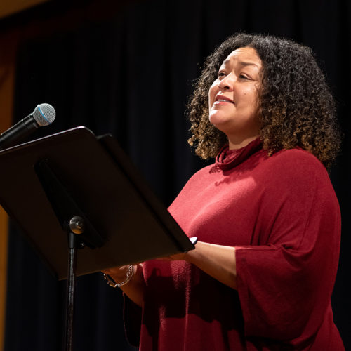 An actor in front of a microphone for a library event